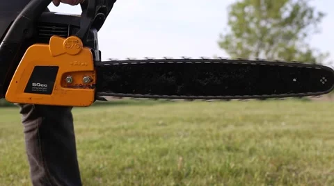 Chainsaw closeup full throttle Stock Footage 64221734