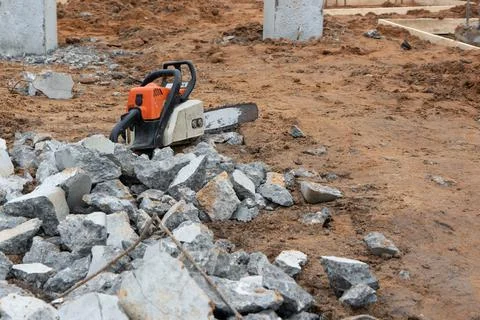 Chainsaw at construction site for foundation Stock Photos
