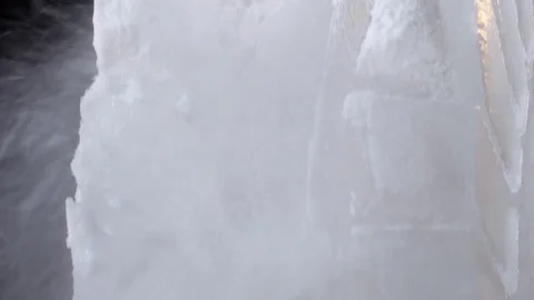 Chainsaw cutting block of ice. closeup of ice carver making ice sculpture Stock Footage 128327491