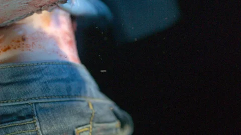 Chainsaw cutting through jeans and flesh Stock Footage 127948674