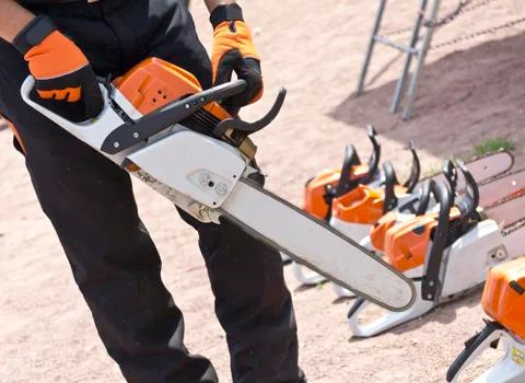 Chainsaw in the hands of men Stock Photos