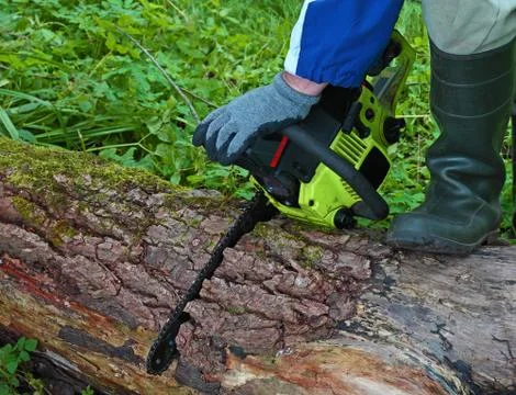 Chainsaw stuck in a wood Stock Photos