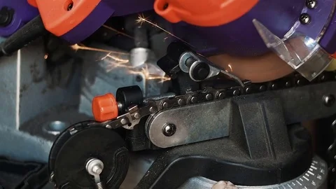 Chainsaw tooth sharpening for wood cutting with an electric tool with sparks Stock Footage 83340556