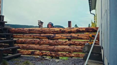 Chainsaw Work in Progress: Cutting Through a Wooden Log Fence Stock Footage 338315205