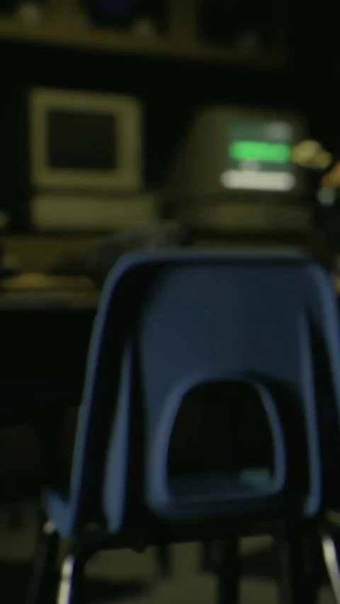 Chair in front of a desk with computers in a classroom setting during the day Stock Footage 332228187