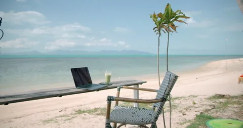Chair, lap top computer and smartphone, at the beach on tropical destination Video stock 154936732