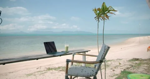 Chair, lap top computer and smartphone, at the beach on tropical destination Video stock 154978152