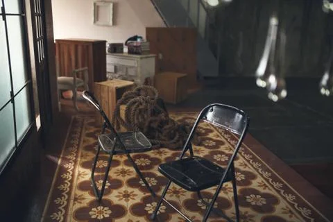 Chair left empty from human conversation in warehouse Stock-Fotos
