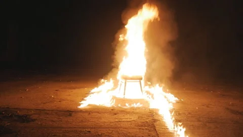 The chair lights up in the fire Stock Footage 97457311