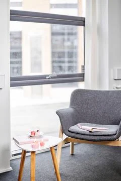 A chair sitting in front of a window Stock Photos