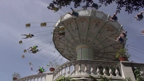 Chair swing ride rotating wave Chair-O-Planes white Tibidabo low angle Stock Footage 324912513