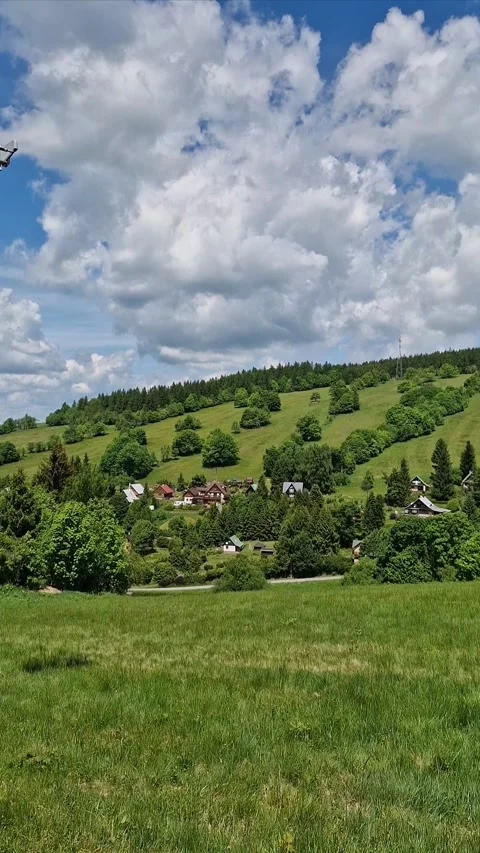 Chairlift empty without people in the middle of a beautiful green landscape Stock Footage 310542663
