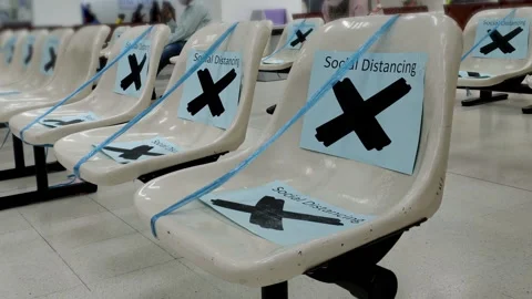 Chairs at Airport With Social Distancing Signs Blocked Due to Coronavirus Stock Footage