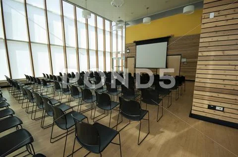 Chairs And Projection Screen In Empty Room