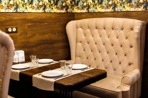 Chairs and sofas in a cafe on the table of glasses Stock Photos