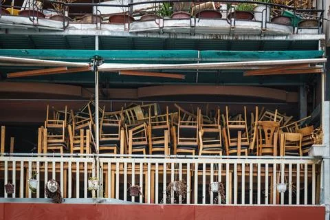 Chairs and Stools Stacked  in an Empty Closed Restaurant Stock Photos