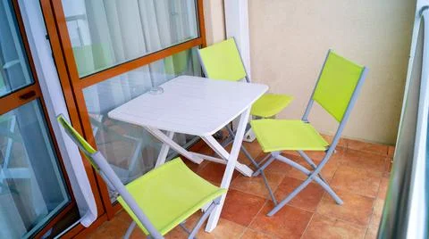 Chairs and table on the balcony Stock Photos