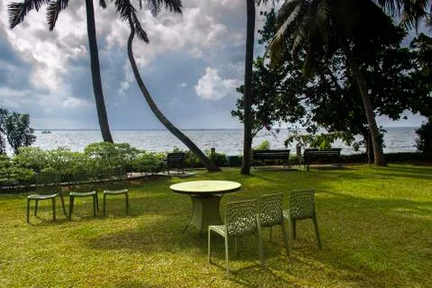 Chairs and table in a lawn Stock Photos