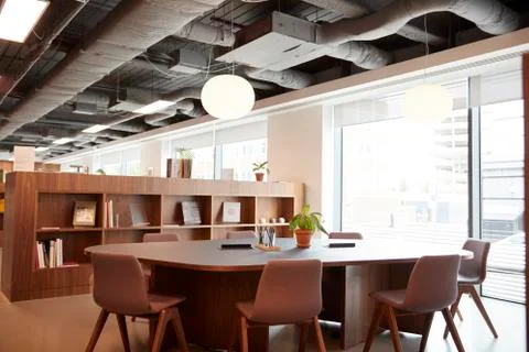 Chairs Around Table In Empty Modern Meeting Area Of Office Stock Photos