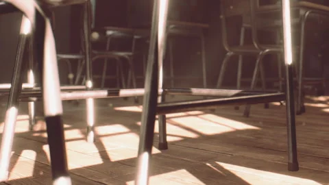 Chairs arranged in a room with sunlight casting shadows on the floor Stock Footage 345060370