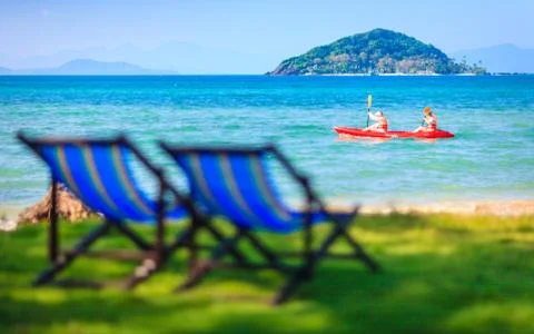 Chairs on beach at tropical island Stock Photos