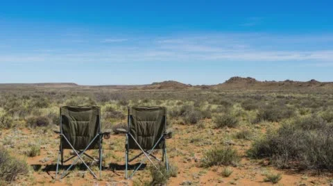 Chairs in a desert landscape Stock Footage 60014720