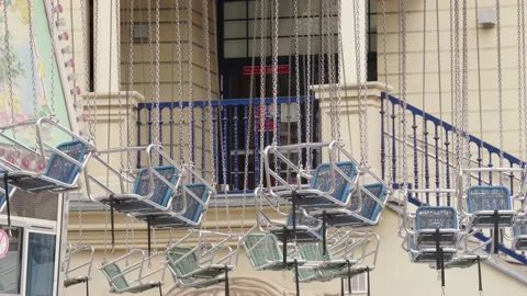 Chairs of Flying Carousel swinging in the wind. Prater Fun Park in Vienna Stock Footage 231225700