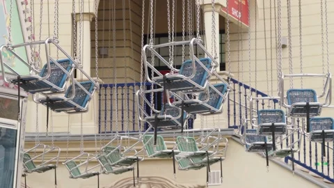 Chairs hanging from Carousel swinging in the wind. Closed Prater Park in Vien Stock Footage 231225705
