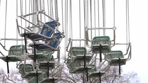 Chairs hanging from Carousel swinging in the wind. Closed Prater Fun Park Stock Footage 231411049