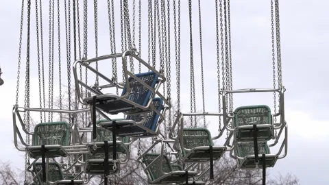 Chairs hanging from Carousel swinging in the wind. Closed Prater Fun Park Stock Footage 231411159