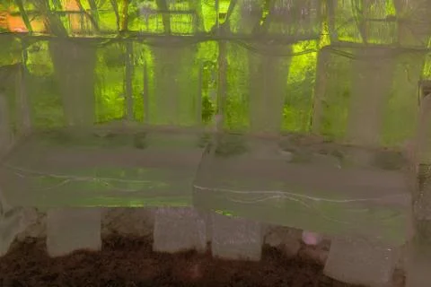 Chairs of ice blocks inside igloo Stock Photos