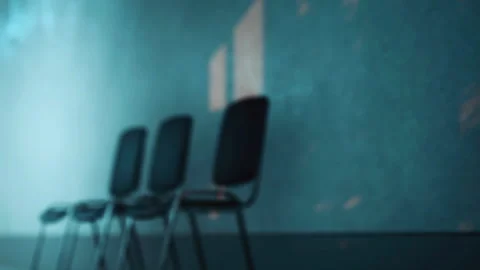 Chairs line up in a room casting shadows on the wall during daylight Stock Footage 345000774