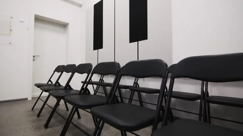 Chairs lined up against wall with decorations fill up hall Видео 295664336