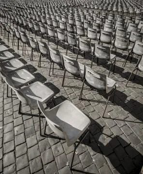 Chairs in a row on a square Stock Photos