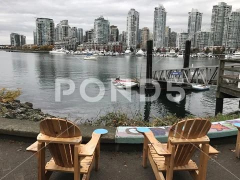 Chairs on the sea wall Stock Photos