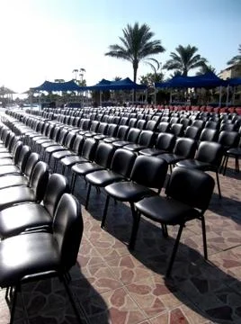 The chairs for spectators are in straight rows. Stock Photos