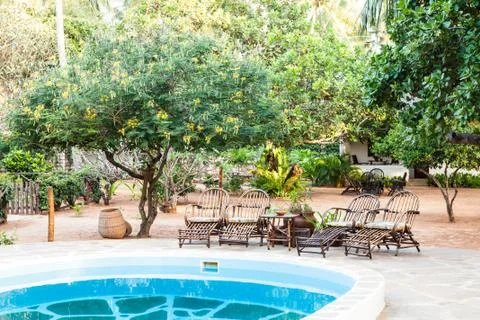 Chairs on swimming pool border Stock Photos
