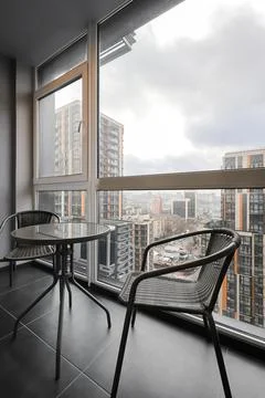 Chairs with table in the loggia Stock Photos