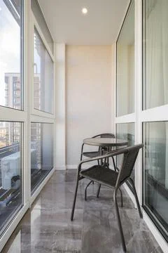 Chairs with table in the loggia Stock-Fotos