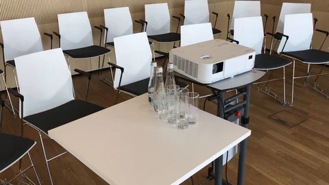 Chairs video projector table water bottle Stock Footage 90783392