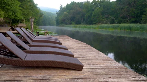 Chaise longues on river Stock Footage 87919646