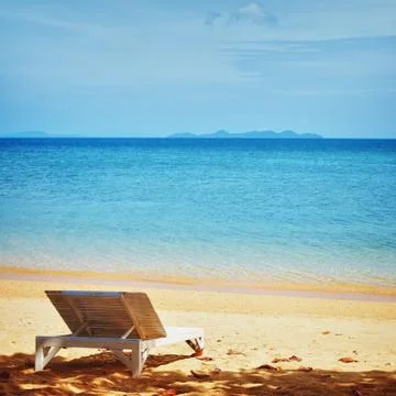 Chaise lounge on a beach Stock Photos