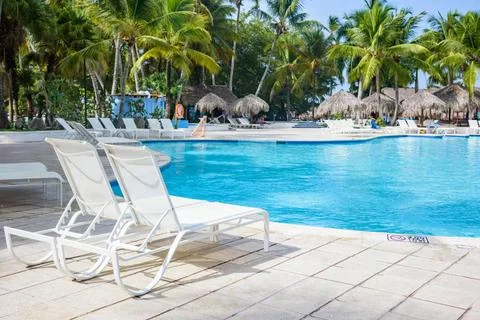 Chaise lounge by the pool Two deck chairs near the swimming pool. Copyrigh... Фото