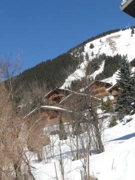 Chalet on snowy hillside.. Stock Photos