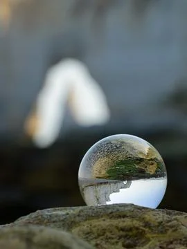 Chalk cliffs of Etretat seen through glass sphere Stock Photos