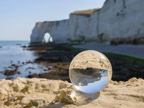 Chalk cliffs of Etretat seen through glass sphere Stock Photos