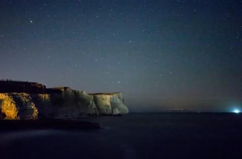 Chalk cliffs of Seaford Head under starry sky. Stock Photos