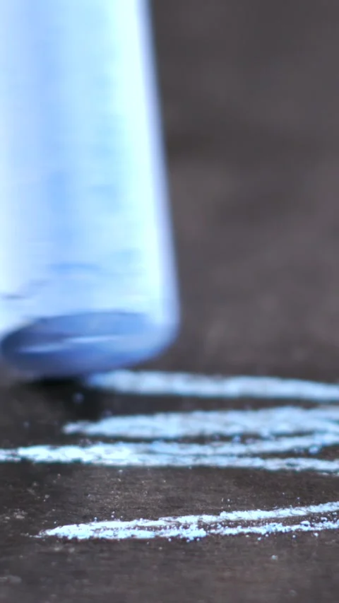 Chalk drawing in progress on a dark surface with close-up focus Stock Footage 341273097