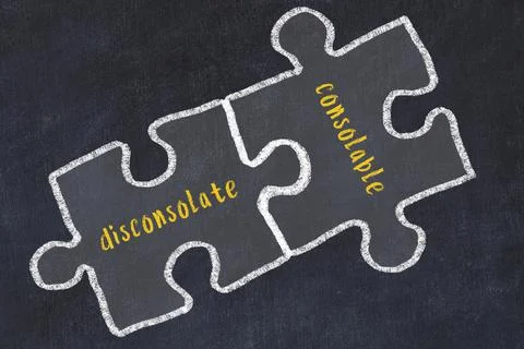 Chalk drawing of two puzzles with words disconsolate and consolable. Concept  Stock Photos