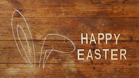 Chalk-drawn ears. Rabbit ears on a wooden background. Happy easter Stock Photos